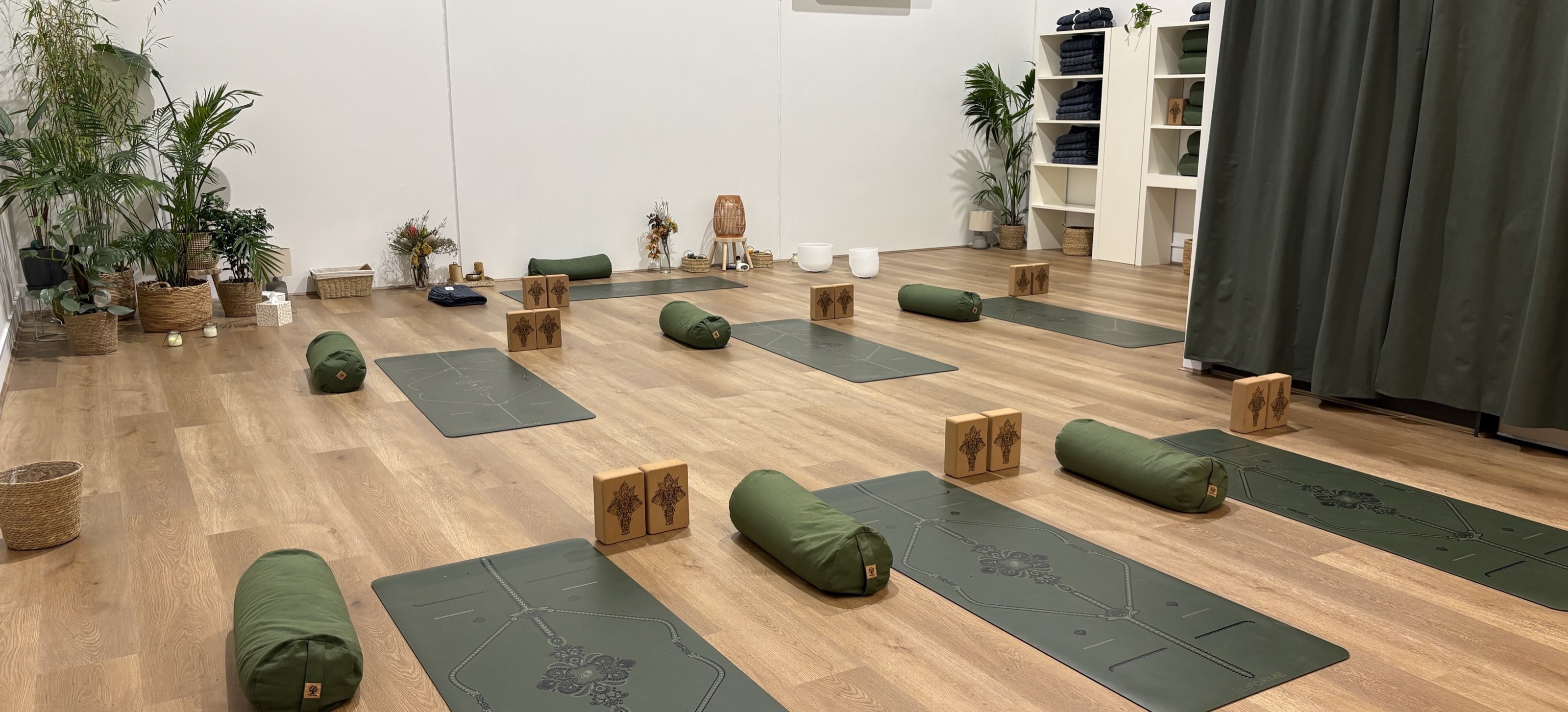 The Novara studio set up for a class — mats, bolsters and blocks laid out